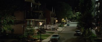 Movie still from “Kick-Ass” (2010), directed by Matthew Vaughn – A car parked on the side of the street at night; Extreme Wide shot, High angle