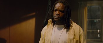 Movie still from “Kick-Ass” (2010), directed by Matthew Vaughn – A person with dreadlocks; Close Up shot, Low angle