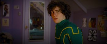 Movie still from “Kick-Ass” (2010), directed by Matthew Vaughn – A young man in a green and yellow sweater; Close Up shot, Over the shoulder angle
