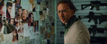 Movie still from “Kick-Ass” (2010), directed by Matthew Vaughn – A man in glasses and a sweater standing in front of a wall; Close Up shot, Over the shoulder angle