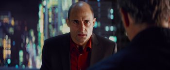 Movie still from “Kick-Ass” (2010), directed by Matthew Vaughn – A man in a red shirt and a black jacket; Close Up shot, Over the shoulder angle