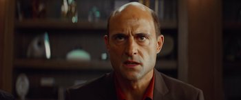 Movie still from “Kick-Ass” (2010), directed by Matthew Vaughn – A man with a bald head is looking at the camera; Close Up shot, Over the shoulder angle