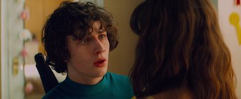 Movie still from “Kick-Ass” (2010), directed by Matthew Vaughn – A young man is looking at a woman in the mirror; Close Up shot, Over the shoulder angle