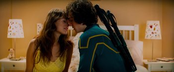 Movie still from “Kick-Ass” (2010), directed by Matthew Vaughn – A man and a woman are kissing each other; Medium shot, Over the shoulder angle