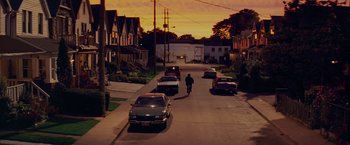 Movie still from “Kick-Ass” (2010), directed by Matthew Vaughn – A man riding a bike down a street at night; Extreme Wide shot, High angle