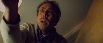 Movie still from “Kick-Ass” (2010), directed by Matthew Vaughn – A person wearing glasses; Close Up shot, Low angle