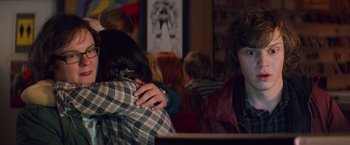 Movie still from “Kick-Ass” (2010), directed by Matthew Vaughn – A couple of people that are hugging in a room; Medium shot, Over the shoulder angle