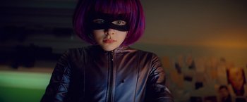 Movie still from “Kick-Ass” (2010), directed by Matthew Vaughn – A woman with purple hair wearing a purple mask; Close Up shot, Low angle