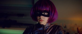 Movie still from “Kick-Ass” (2010), directed by Matthew Vaughn – A woman with purple hair and a black mask; Close Up shot, Low angle