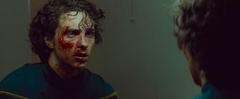 Movie still from “Kick-Ass” (2010), directed by Matthew Vaughn – A young man with blood all over his face; Close Up shot, Low angle