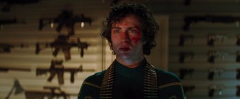 Movie still from “Kick-Ass” (2010), directed by Matthew Vaughn – A man with bullet holes on his face; Close Up shot, Low angle