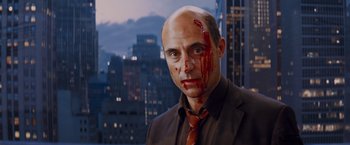 Movie still from “Kick-Ass” (2010), directed by Matthew Vaughn – A man with blood on his face and head; Close Up shot, Over the shoulder angle