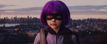 Movie still from “Kick-Ass” (2010), directed by Matthew Vaughn – A young person with purple hair and a purple mask; Close Up shot, Low angle