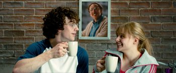 Movie still from “Kick-Ass 2” (2013), directed by Jeff Wadlow – A man and a woman holding coffee cups; Medium shot, Over the shoulder angle