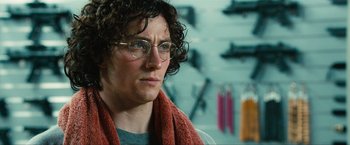 Movie still from “Kick-Ass 2” (2013), directed by Jeff Wadlow – A man with glasses is wearing a red scarf; Close Up shot, Over the shoulder angle