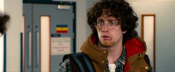 Movie still from “Kick-Ass 2” (2013), directed by Jeff Wadlow – A man with a brown jacket and a brown beard; Close Up shot, Over the shoulder angle