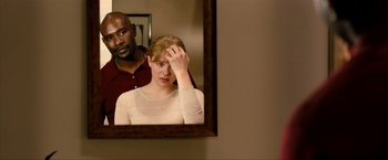 Movie still from “Kick-Ass 2” (2013), directed by Jeff Wadlow – A man and a woman looking in a mirror; Close Up shot, Over the shoulder angle
