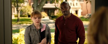 Movie still from “Kick-Ass 2” (2013), directed by Jeff Wadlow – A man and a woman standing next to each other; Medium shot, Over the shoulder angle