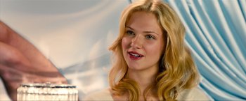 Movie still from “Kick-Ass 2” (2013), directed by Jeff Wadlow – A woman with blonde hair is smiling for the camera; Close Up shot, Over the shoulder angle