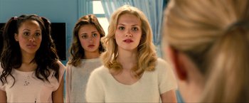 Movie still from “Kick-Ass 2” (2013), directed by Jeff Wadlow – Two young women looking in the same direction in a mirror; Close Up shot, Over the shoulder angle