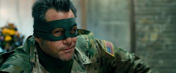 Movie still from “Kick-Ass 2” (2013), directed by Jeff Wadlow – A person wearing a costume; Close Up shot, Over the shoulder angle