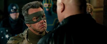 Movie still from “Kick-Ass 2” (2013), directed by Jeff Wadlow – A man with a mask on looking at another man with a mask on his face; Close Up shot, Over the shoulder angle