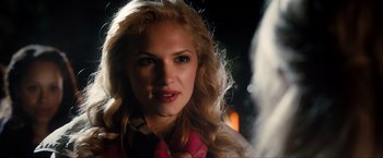 Movie still from “Kick-Ass 2” (2013), directed by Jeff Wadlow – A beautiful blonde woman with long hair; Close Up shot, Over the shoulder angle