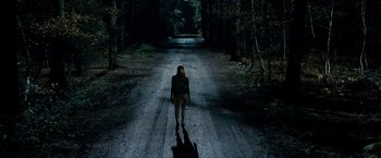 Movie still from “Kick-Ass 2” (2013), directed by Jeff Wadlow – A woman walking down a dark road at night; Extreme Wide shot, High angle