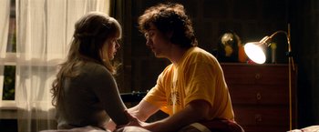 Movie still from “Kick-Ass 2” (2013), directed by Jeff Wadlow – A man and a woman sitting on a bed; Medium shot, Over the shoulder angle
