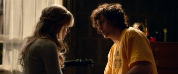 Movie still from “Kick-Ass 2” (2013), directed by Jeff Wadlow – A man and a woman standing next to each other; Medium shot, Over the shoulder angle