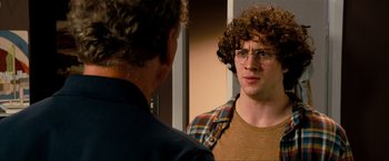 Movie still from “Kick-Ass 2” (2013), directed by Jeff Wadlow – A man with curly hair and glasses looking at himself in the mirror; Close Up shot, Over the shoulder angle