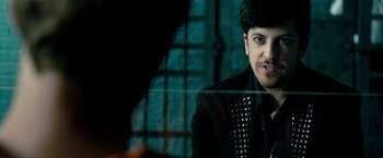 Movie still from “Kick-Ass 2” (2013), directed by Jeff Wadlow – A person wearing a suit and tie; Close Up shot, Over the shoulder angle