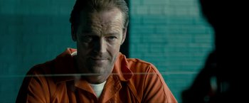 Movie still from “Kick-Ass 2” (2013), directed by Jeff Wadlow – A person wearing an orange shirt; Close Up shot, Over the shoulder angle