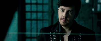 Movie still from “Kick-Ass 2” (2013), directed by Jeff Wadlow – A person wearing a suit and tie; Close Up shot, Over the shoulder angle