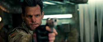 Movie still from “Kick-Ass 2” (2013), directed by Jeff Wadlow – A person holding a gun; Close Up shot, Over the shoulder angle