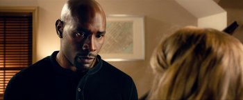 Movie still from “Kick-Ass 2” (2013), directed by Jeff Wadlow – A person wearing a black shirt; Close Up shot, Over the shoulder angle