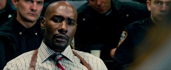 Movie still from “Kick-Ass 2” (2013), directed by Jeff Wadlow – A person wearing a shirt and a tie; Close Up shot, Over the shoulder angle