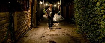 Movie still from “Kick-Ass 2” (2013), directed by Jeff Wadlow – A person standing in a dark alley at night; Wide shot, Low angle