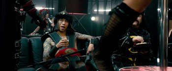 Movie still from “Kick-Ass 2” (2013), directed by Jeff Wadlow – A man in a samurai outfit holding a guitar; Medium shot, Over the shoulder angle
