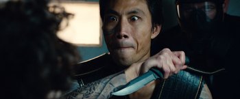 Movie still from “Kick-Ass 2” (2013), directed by Jeff Wadlow – A person holding a knife; Close Up shot, Over the shoulder angle