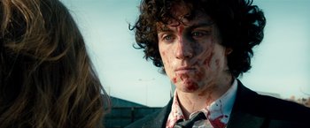 Movie still from “Kick-Ass 2” (2013), directed by Jeff Wadlow – A young man with blood all over his face; Close Up shot, Over the shoulder angle