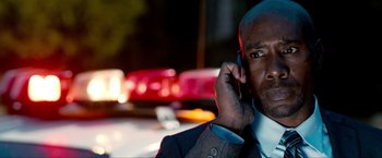 Movie still from “Kick-Ass 2” (2013), directed by Jeff Wadlow – A person talking on a cell phone; Close Up shot, Low angle