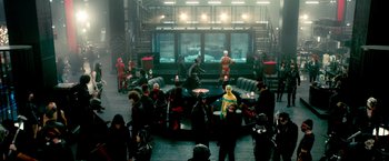 Movie still from “Kick-Ass 2” (2013), directed by Jeff Wadlow – A group of people sitting around a room; Wide shot, High angle