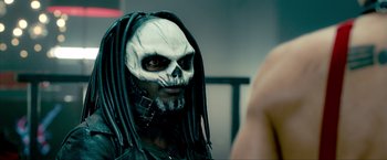 Movie still from “Kick-Ass 2” (2013), directed by Jeff Wadlow – A man with a skull face paint and dreadlocks; Close Up shot, Over the shoulder angle