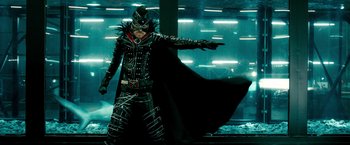 Movie still from “Kick-Ass 2” (2013), directed by Jeff Wadlow – A man dressed in costume with a black cape; Medium shot, Low angle
