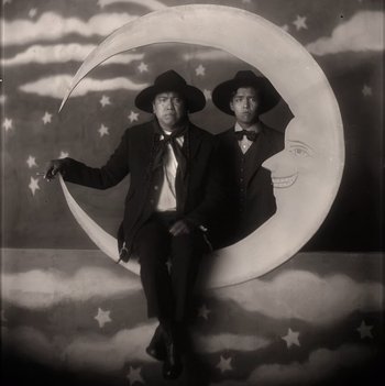 Movie still from “Killers of the Flower Moon” (2023), directed by Martin Scorsese – A couple of men sitting on top of the moon; Medium shot, Low angle