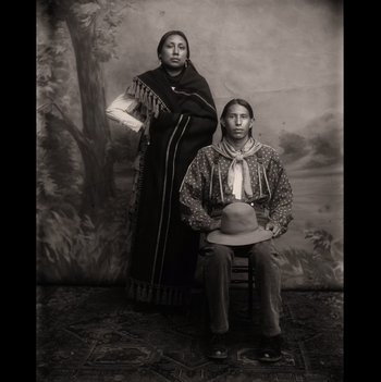 Movie still from “Killers of the Flower Moon” (2023), directed by Martin Scorsese – A man and a woman are posing for a picture; Wide shot, Low angle