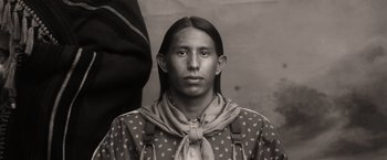 Movie still from “Killers of the Flower Moon” (2023), directed by Martin Scorsese – A man with long hair and a bandana around his neck; Close Up shot, High angle