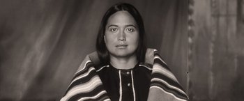 Movie still from “Killers of the Flower Moon” (2023), directed by Martin Scorsese – An old photo of a woman with a blanket around her neck; Close Up shot, High angle
