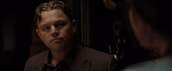 Movie still from “Killers of the Flower Moon” (2023), directed by Martin Scorsese – A person wearing a suit and tie; Close Up shot, Over the shoulder angle